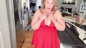 fantasymilfursula teasing her massive tits and big ass in a red dress in the kitchen in this OnlyFans video